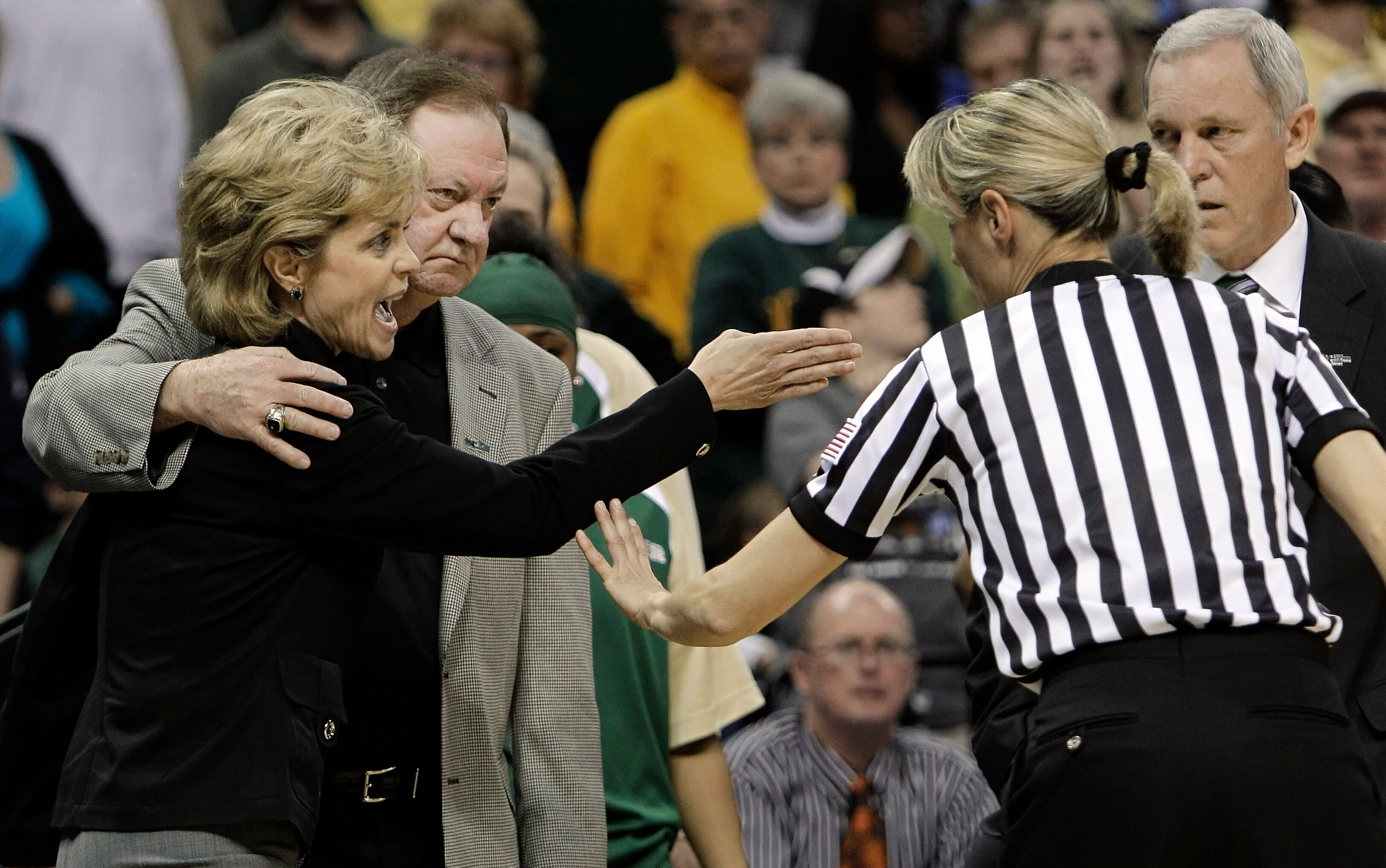 FILE - Baylor coach Kim Mulkey, left, is restrained by assistant Leon Barmore, who was her coach when she played at Louisiana Tech in the early 1980s, as she argues a call in the second half of the NCAA Memphis Regional championship college basketball game against Duke, Monday, March 29, 2010, in Memphis, Tenn. (AP Photo/Mark Humphrey, File)