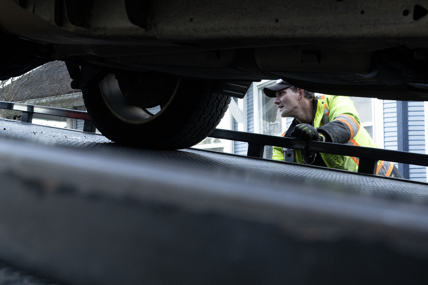Staff Photo by Seth Carpenter / David Clark, a driver for Shackleford Towing & Recovery, operates the control mechanism for his tow truck in St. Elmo.