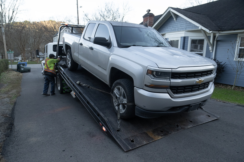 Staff Photo by Seth Carpenter / David Clark, a driver for Shackleford Towing & Recovery, secures ratchet straps to a pickup truck in St. Elmo.