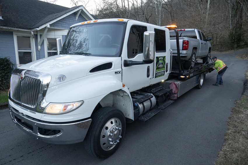 Staff Photo by Seth Carpenter / David Clark, a driver for Shackleford Towing & Recovery, operates the control mechanism for his tow truck in St. Elmo.