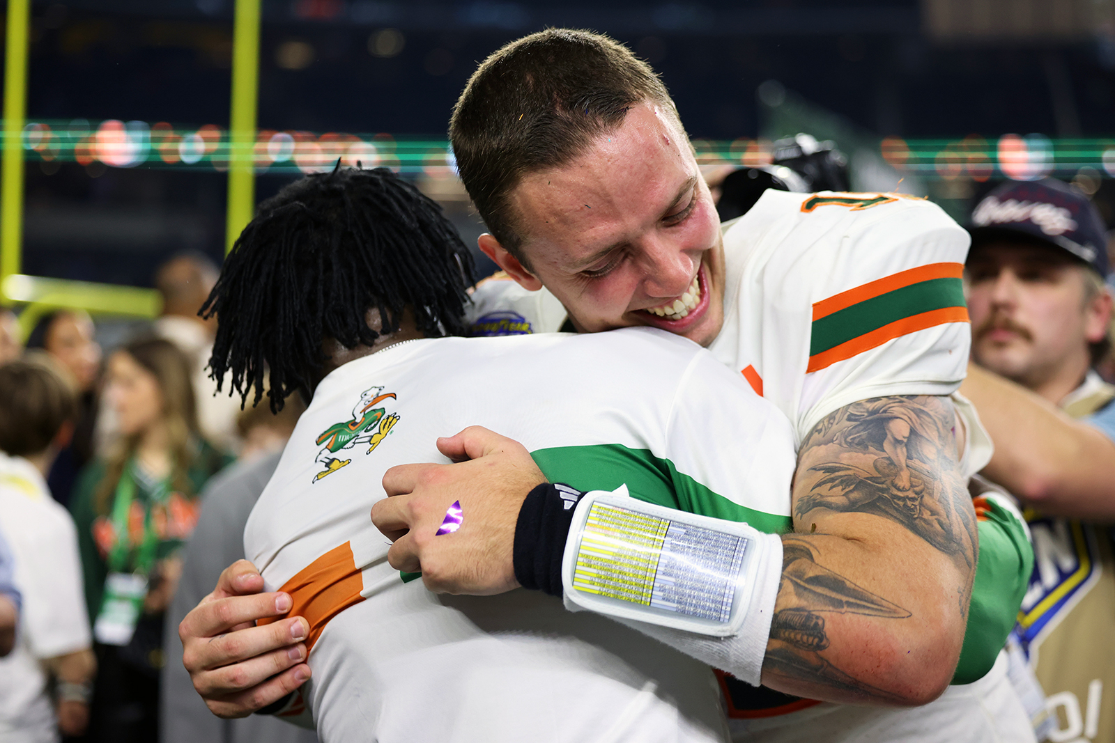 AP photo by Gareth Patterson / Miami quarterback Carson Beck, right, is hugged by former Hurricanes and Dallas Cowboys receiver Michael Irvin after the College Football Playoff's Cotton Bowl quarterfinal Wednesday night at AT&T Stadium in Arlington, Texas.