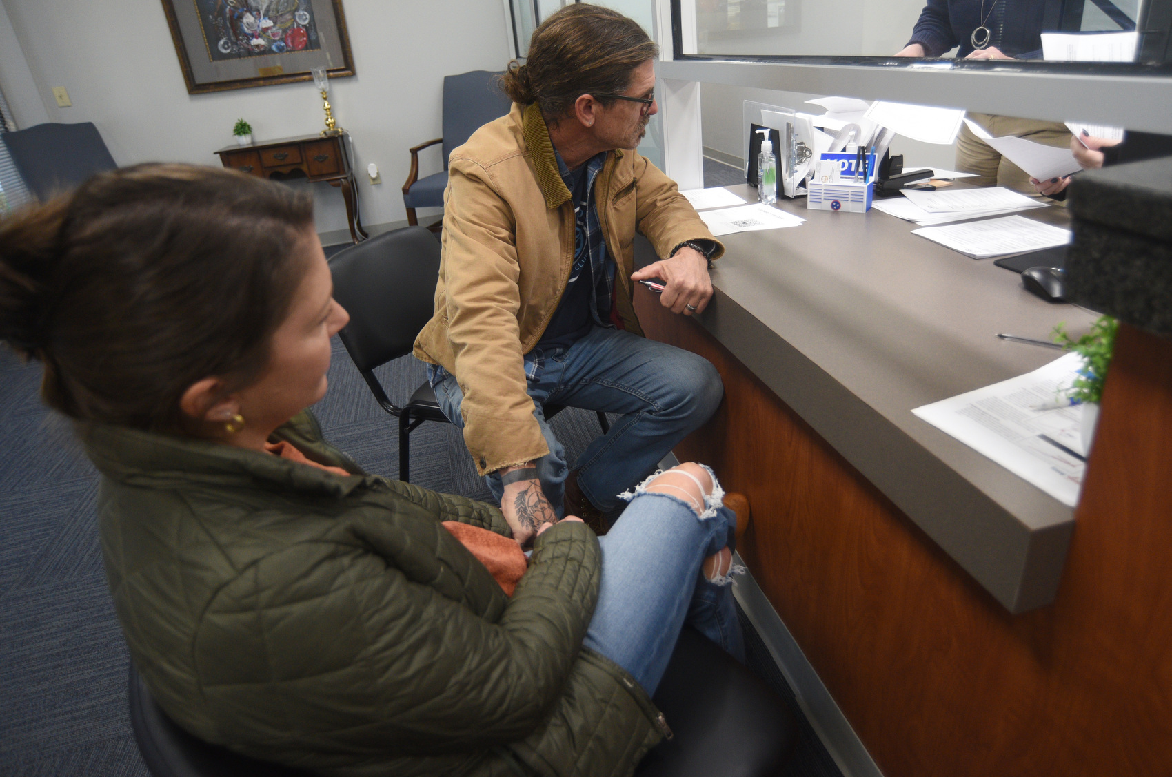 Staff photo by Matt Hamilton / Mark Herndon, Democratic challenger for Hamilton County mayor, holds hands with his wife, Meghan, as he picks up paperwork at the County Elections Office.