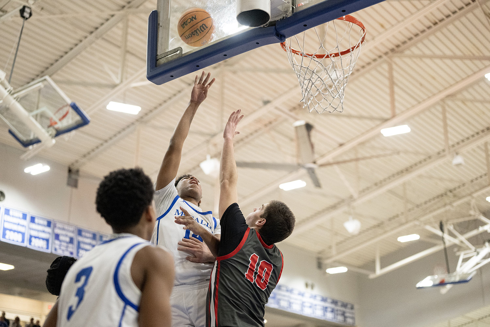 Staff Photo by Seth Carpenter/ McCallie's Trell Knight (14) shoots for the basket midair as Baylor's William Barker (10) tries to block him. McCallie Boys' Basketball was hosting a match against Baylor on Friday, Jan. 16, 2026.