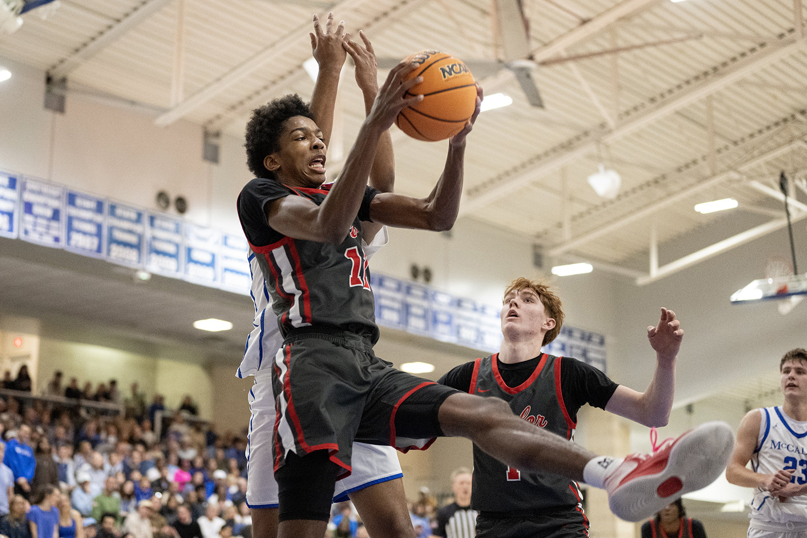 Staff Photo by Seth Carpenter/ Baylor's Ezra Sixto (12) catches a stray ball midair. McCallie Boys' Basketball was hosting a match against Baylor on Friday, Jan. 16, 2026.