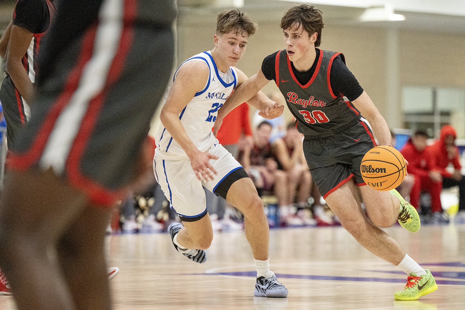 Staff Photo by Seth Carpenter/ Baylor's Karolis Anuskevicius (30) dribbles the ball past McCallie's Ernas Valauskas (23). McCallie Boys' Basketball was hosting a match against Baylor on Friday, Jan. 16, 2026.