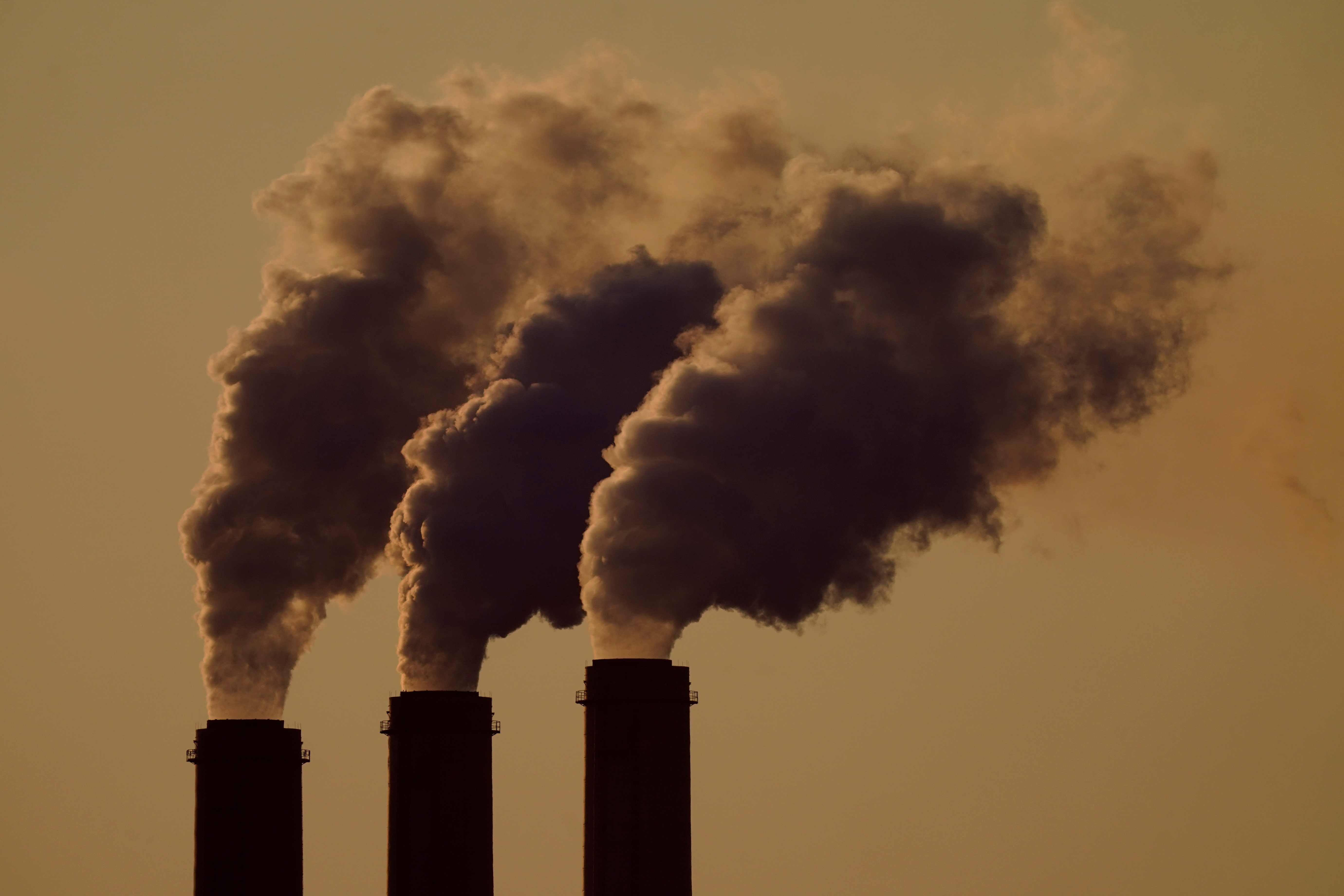 FILE - Emissions rise from the smokestacks at the Jeffrey Energy Center coal power plant as the suns sets, near Emmett, Kansas, Sept. 18, 2021. (AP Photo/Charlie Riedel, File)