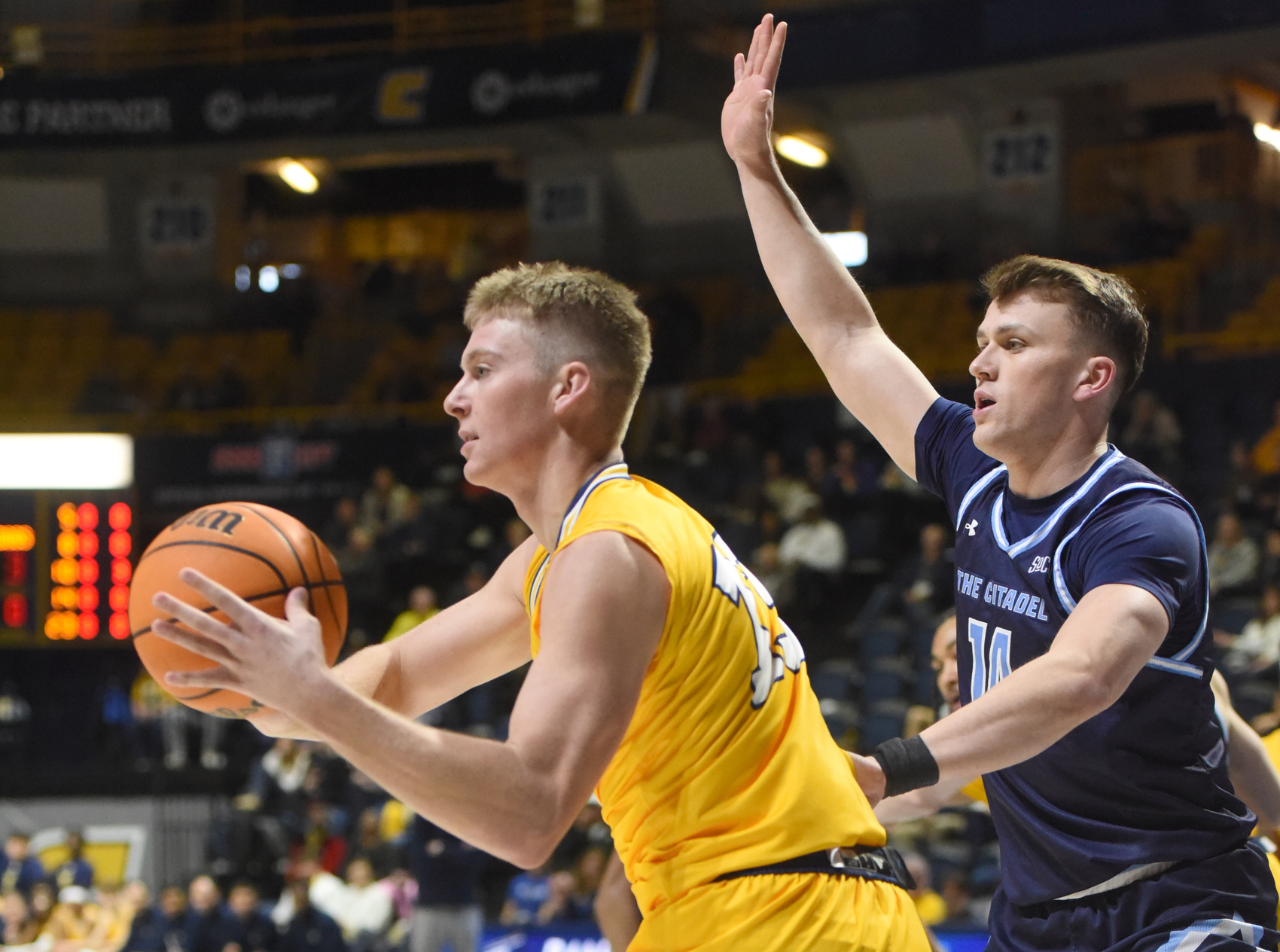 Staff photo by Matt Hamilton / UTC's Houston Holland looks for an outlet to pass while guarded by The Citadel's Carter Kingsbury during Saturday's SoCon game at McKenzie Arena.