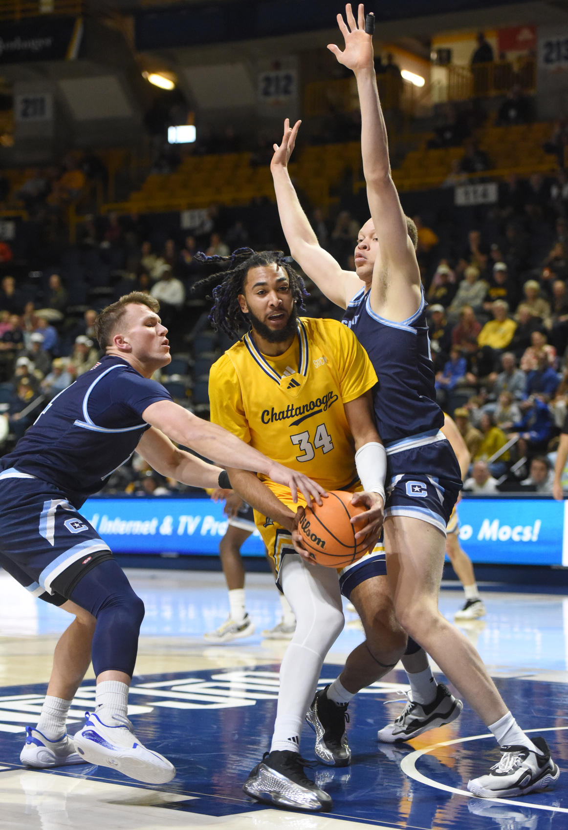 Staff photo by Matt Hamilton/ Citadel (14) Carter Kingsbury and (23) Simeon German steal the ball from UTC (34) Makai Richards during their game at McKenzie Arena on Saturday, Feb. 7, 2026.