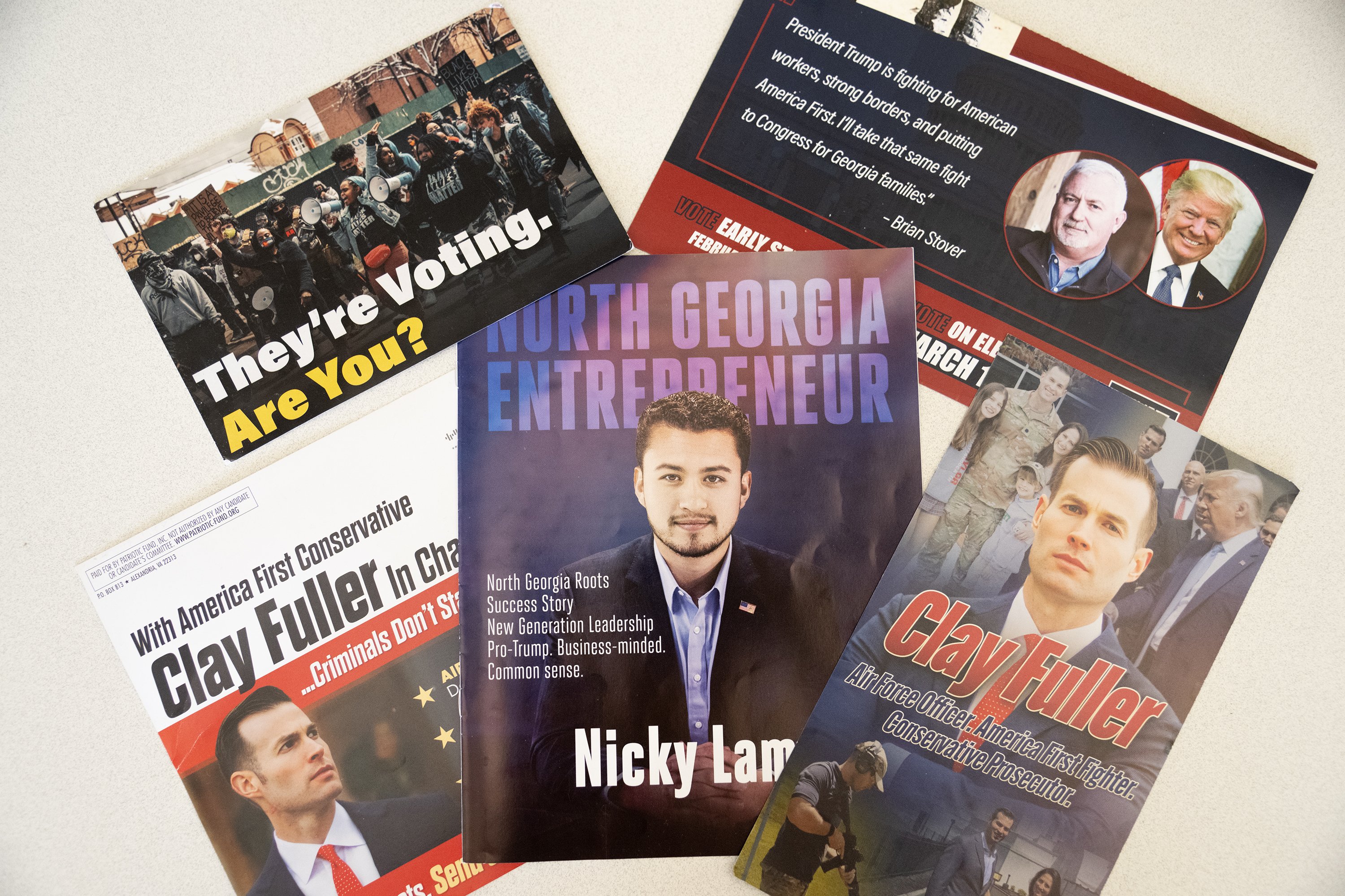 Staff Photo by Seth Carpenter / Campaign mail sent out by various candidates running in the special election for Georgia's 14th Congressional District are spread out on a table.
