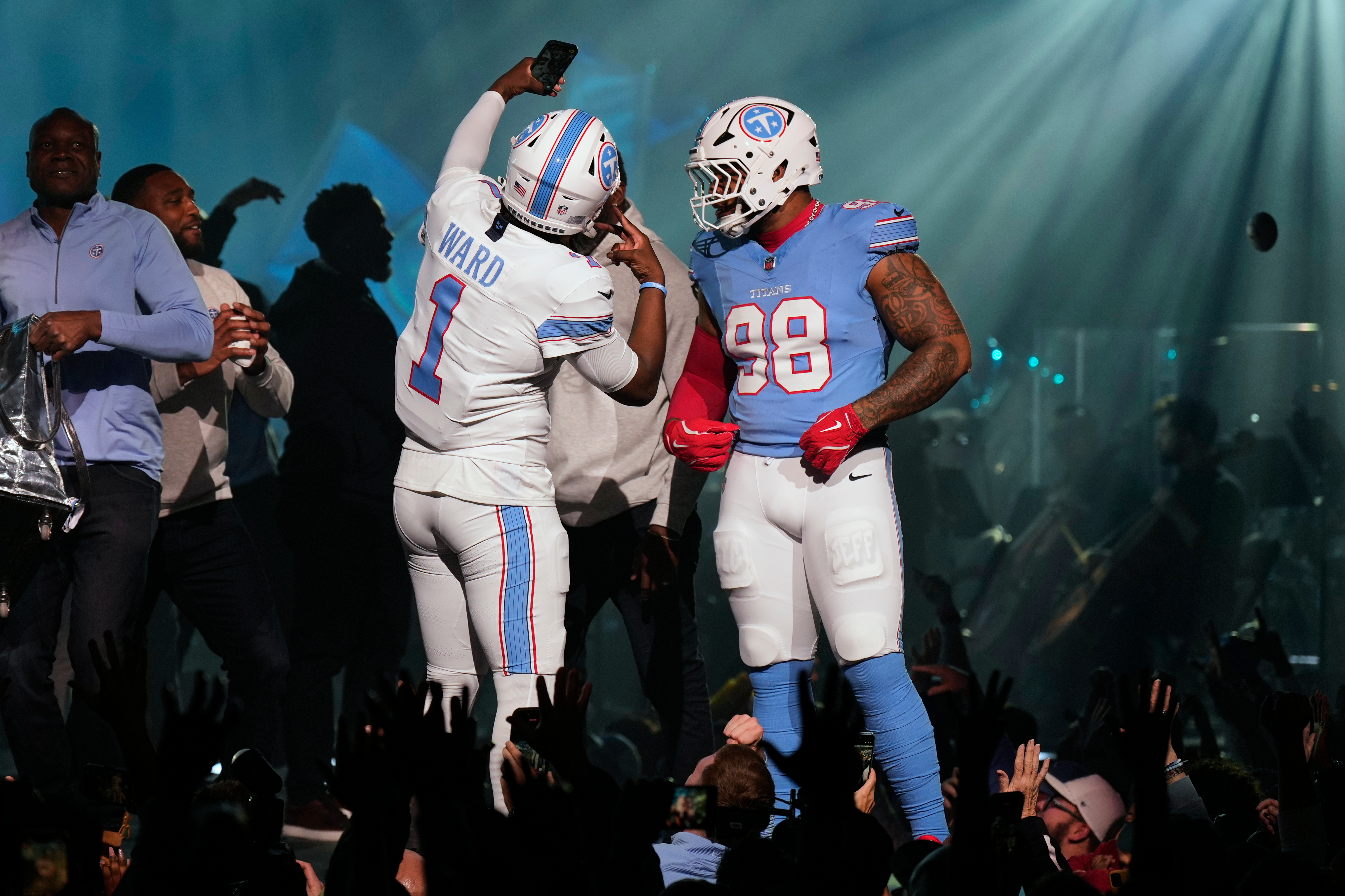 AP photo by George Walker IV / Tennessee Titans quarterback Cam Ward takes a selfie with defensive tackle Jeffrey Simmons as they model new uniforms during the team's unveiling event Thursday night in Nashville.