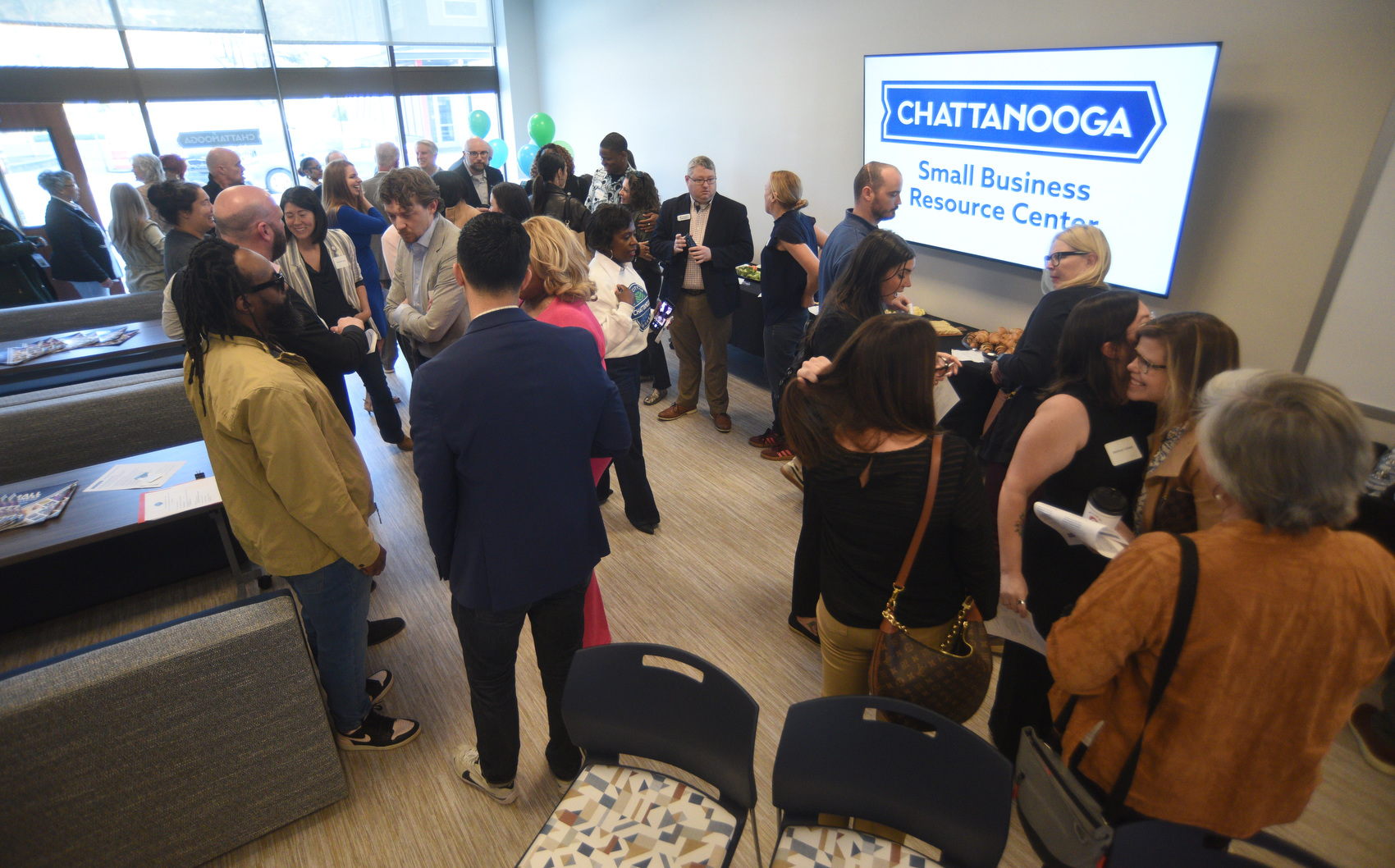Staff photo by Matt Hamilton / Visitors talk before the start of the ribbon cutting ceremony for the Chattanooga Small Business Resource Center on Friday, March 20, 2026.