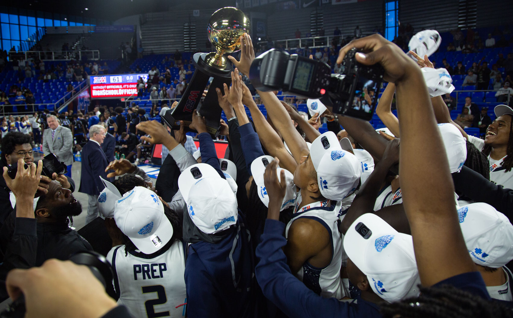 Staff photo by Larry Sullivan II/Members of the Chatt. Prep boys basketball team reach for the state championship trophy after winning the Class 2A basketball state championship game on Saturday, March 21, 2026.
