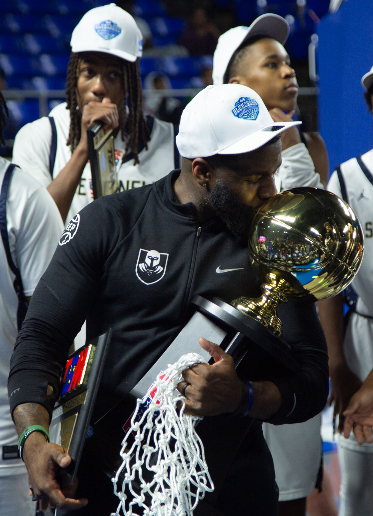 Staff photo by Larry Sullivan II/Chatt. Prep boys basketball Head Coach Christian Collins kisses the state championship trophy after winning the Class 2A basketball state championship game on Saturday, March 21, 2026.
