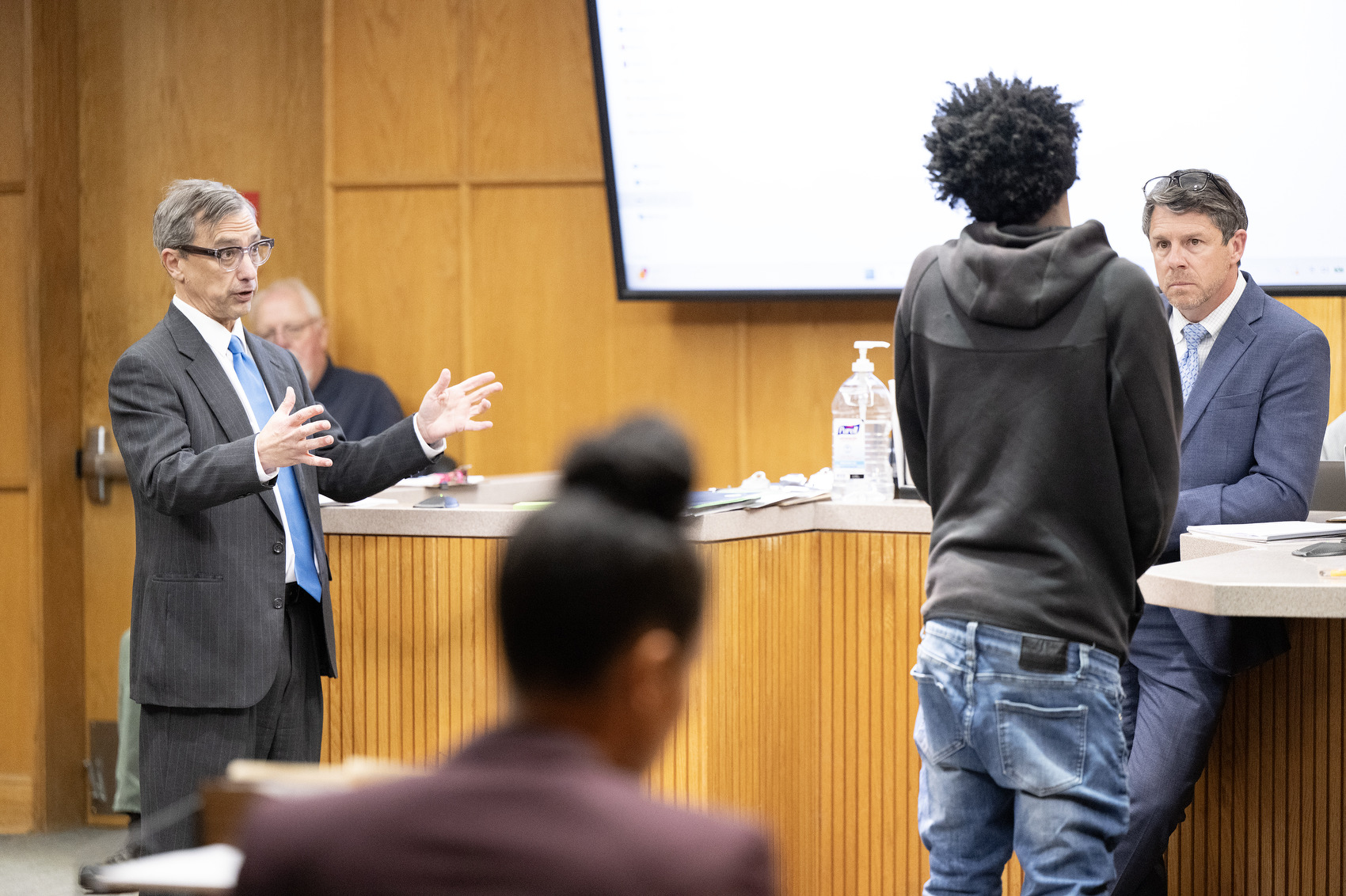 Staff Photo by Seth Carpenter / Attorney Neal Pinkston (left) cross-examines Jaden Rue as attorney Jason Thomas listens in Hamilton County Judge Tori Smith's courtroom. Thomas' client, Terrance Brewer Jr., and Pinkston's client, Milik Woodley, were in a preliminary hearing in connection with their alleged role in the shooting death of Wallace Milam.