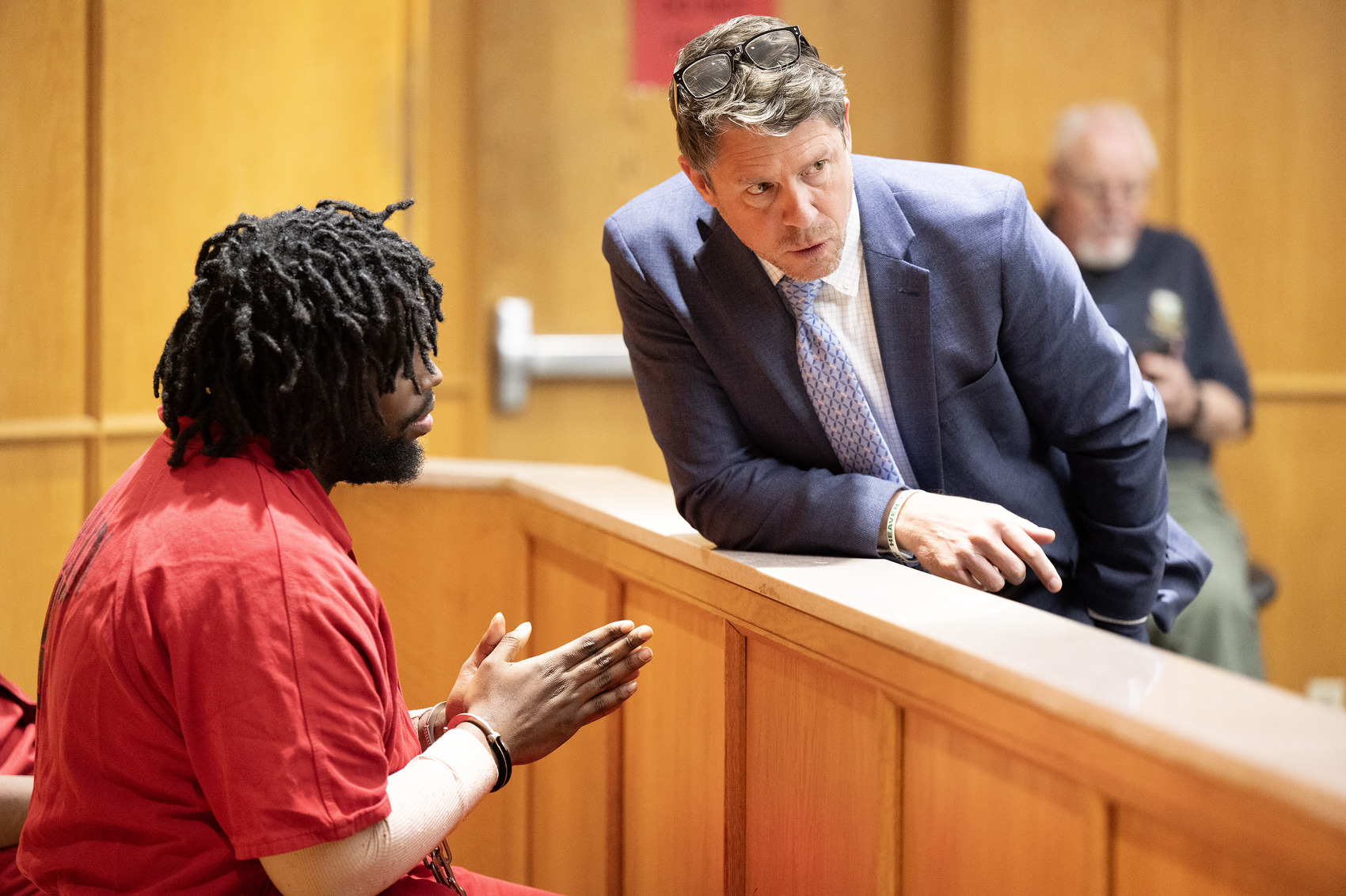 Staff Photo by Seth Carpenter / Attorney Jason Thomas speaks with his client, Terrance Brewer Jr., in Hamilton County Judge Tori Smith's courtroom. Brewer and Milik Woodley were in a preliminary hearing in connection with their alleged role in the shooting death of Wallace Milam.