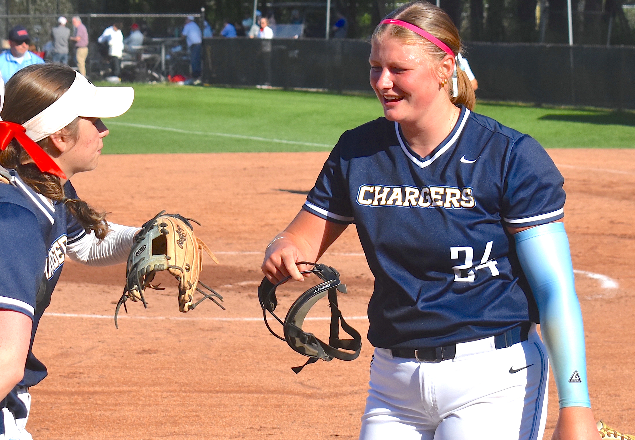 Staff photo by Patrick MacCoon / Chattanooga Christian senior star pitcher Kylie Black (24) is congratulated by teammate Millie Fox, left, during Thursday's 1-0 road victory over Baylor.