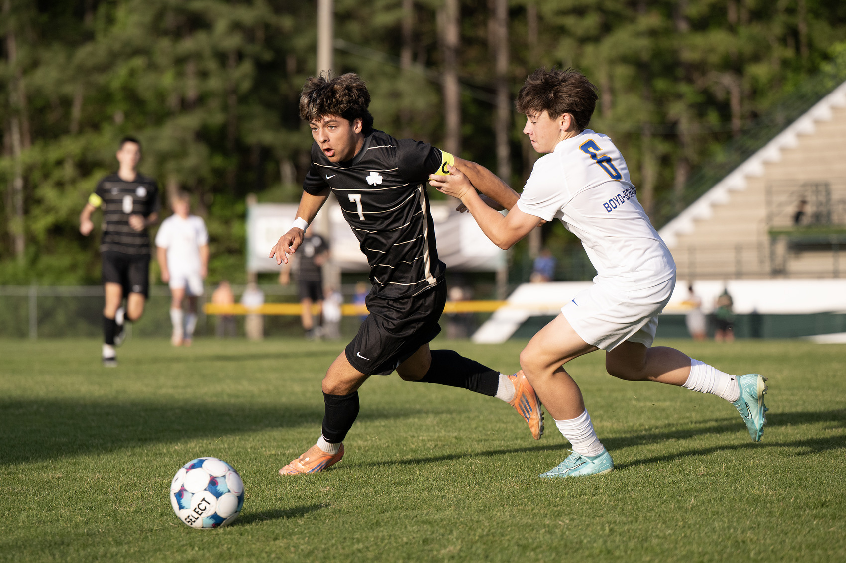 Staff Photo by Seth Carpenter/ Notre Dame's Luke Rosellini (7) chases after the ball alongside Boyd Buchanan's Jim Wood (6) at Notre Dame High School on Friday, April 10, 2026.