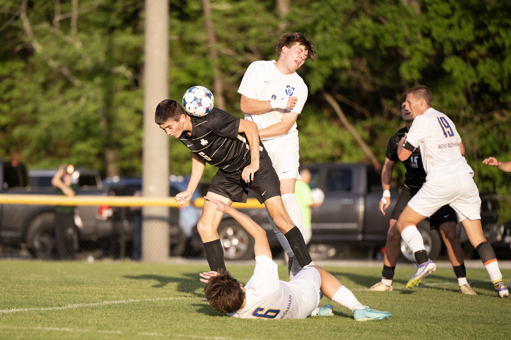 Staff Photo by Seth Carpenter/ Notre Dame's Dax Brown (6) hits the ball with his shoulder ahead of Boyd Buchanan's Justus Wood (3) at Notre Dame High School on Friday, April 10, 2026.