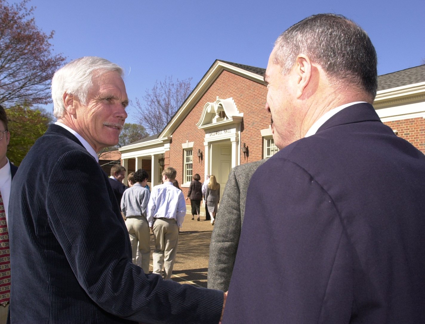 Staff Photo by Alex McMahan / Ted Turner talks with one of his former classmates, Howard Levine, after speaking with Upper School students in 2014 at the McCallie School.