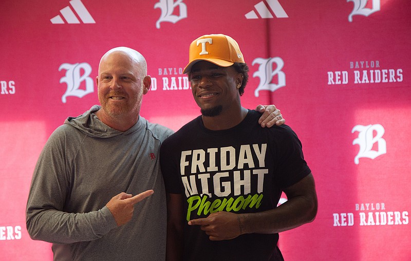 Staff photo by Larry Sullivan II/David Gabriel Georges, right, poses with Head football coach Erik Kimrey at his commitment ceremony at the Baylor Probasco Academic Center on July 22, 2026.