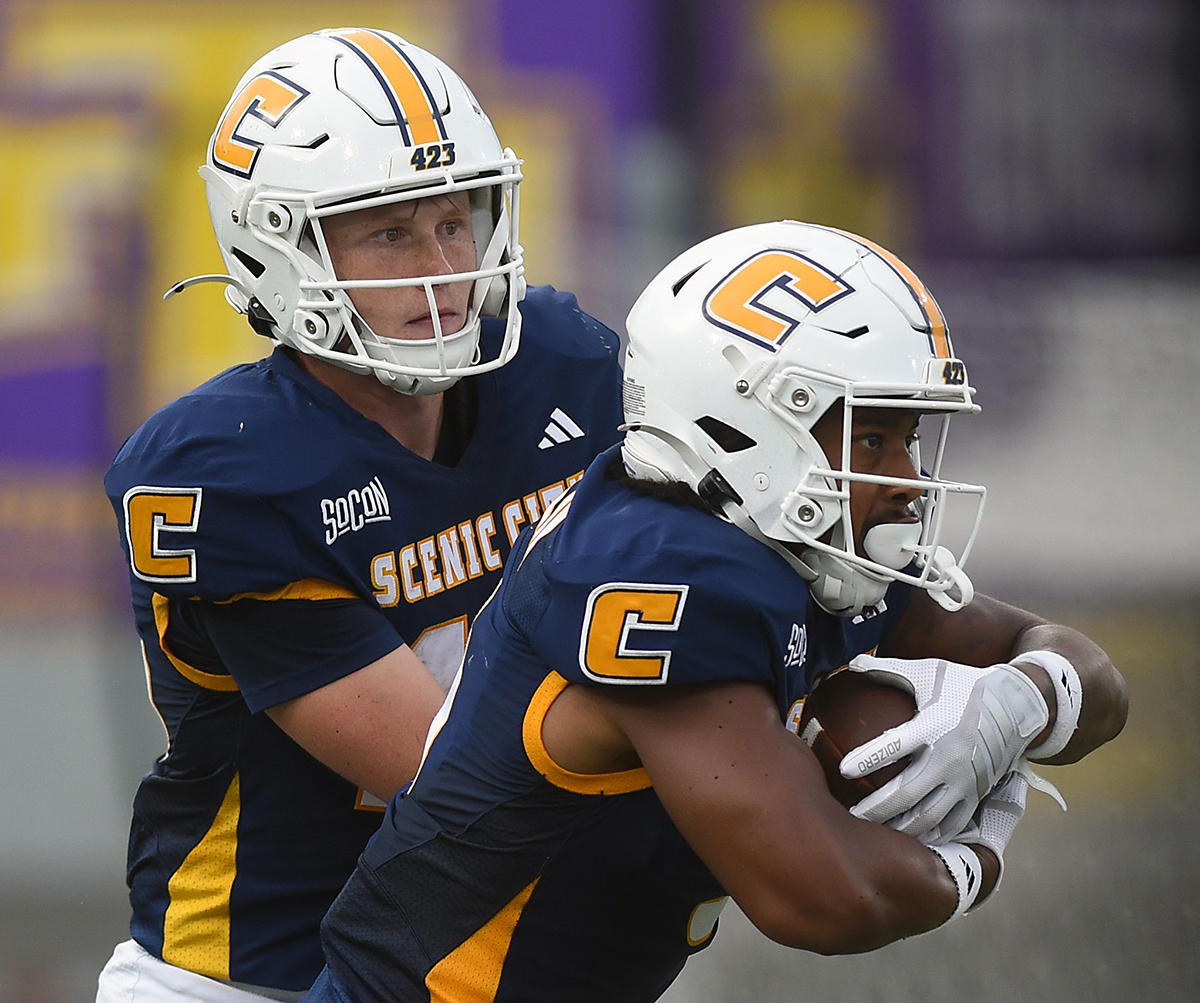 Staff Photo by Matt Hamilton / UTC quarterback Battle Alberson, left, hands off to running back Kevin Lalin during Saturday's game against Tennessee Tech at Finley Stadium.