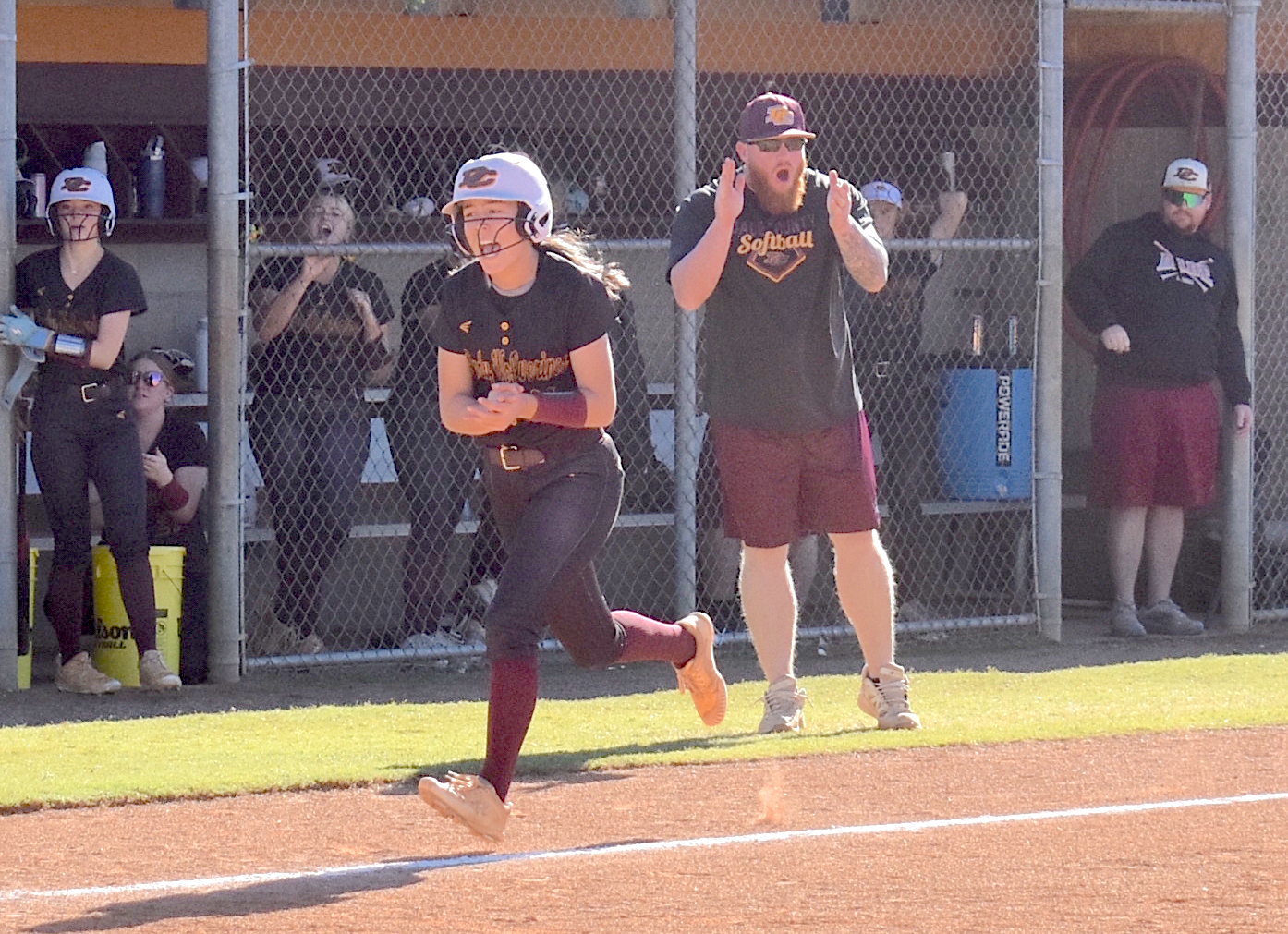 Staff photo by Patrick MacCoon / Dade County head coach Stephen Graham and freshman Alli Stevens celebrate during Tuesday's home game against Metter in the second round of the GHSA Class AA state playoffs.