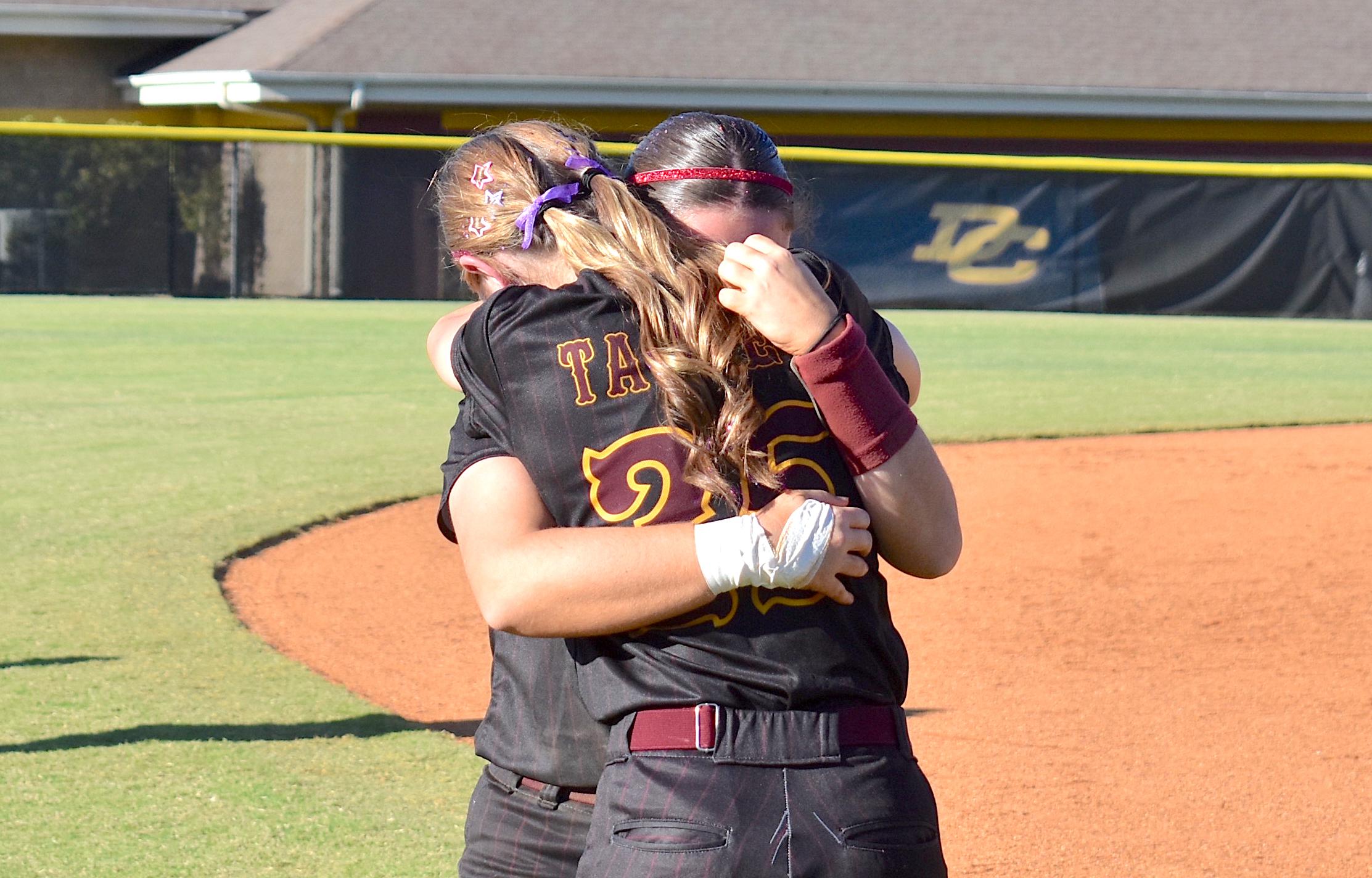 Staff photo by Patrick MacCoon / Dade County seniors Riley Talley (25) and Miley Chambers embrace after the Lady Wolverines' season came to a close with Tuesday's 6-4 home defeat in a decisive Game 3 against Metter in the second round of the GHSA Class AA playoffs.