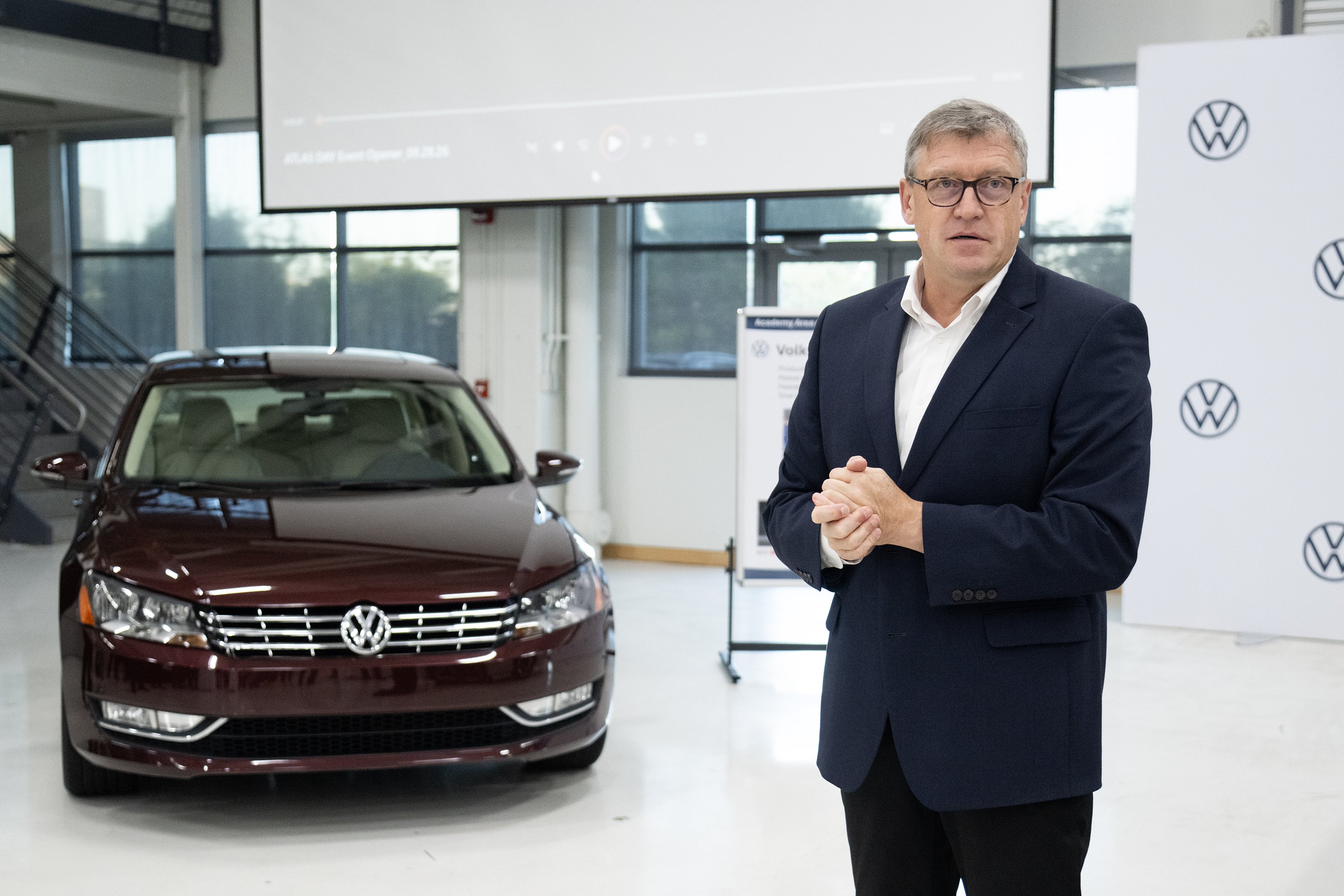 Staff Photo by Seth Carpenter/ Henning Habicht, head of Volkswagen Chattanooga operations, speaks in front of a Volkswagen Passat during an Atlas Day celebration at Volkswagen Chattanooga on Tuesday, Sept. 29, 2026. The plant was reportedly a possible location for Audi production, though Audi now plans to build a plant in Georgia.