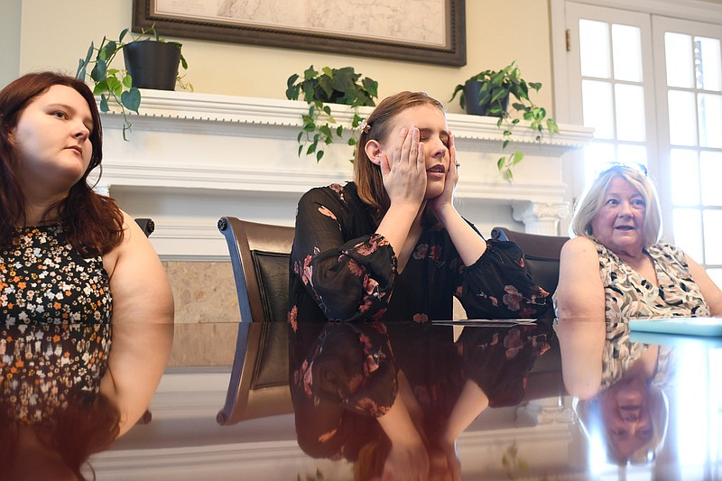 Staff Photo by Robin Rudd / Andrea White, center, talks about her mother, while sister, Samantha, left, and grandmother, Donna White listen.  The family of Carol Rene White spoke with the Times Free Press at the law offices of Davis and Hoss, in Fort Wood, on August 2, 2022.