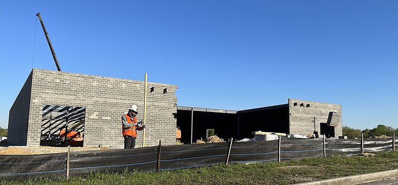 Staff Photo by Dave Flessner / Workers continue to build the new showroom and service station Wednesday that will be leased to Tesla for its Chattanooga store, which is expected to open later this year.