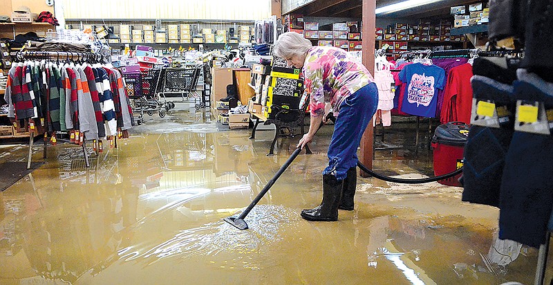 Staff photo by John Rawlston/Chattanooga Times Free Press - Jul 11, 2013
Ellen Lambert, who has worked at the South Pittsburg Hammer's store for 36 years, vacuums water out of the floor Thursday as South Pittsburg residents deal with the aftermath of flash flooding that happened Wednesday night.