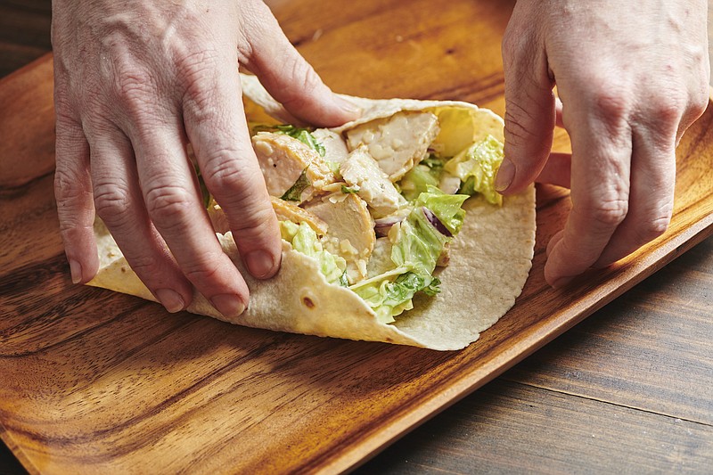 There is little debate that the sandwich is the mainstay of most kids’ lunches, but wraps, like this chicken Caesar, have also taken their place in the pantheon of sandwich possibilities. / Cheyenne Cohen via AP/File