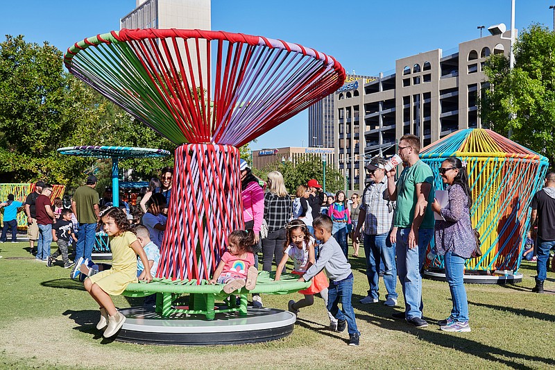 Photo contributed by Brian Wancho / Children in El Paso, Texas, play on one of the spinning tops of the Los Trompos 8 interactive art installation that is to come to Chattanooga next spring.