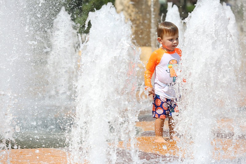 Staff photo by Erin O. Smith / John Michael Sabourin, 2, plays in the fountain Monday, August 12, 2019 at Coolidge Park in Chattanooga, Tennessee. The Sabourin family lives just across the river from Coolidge Park and makes regular trips to the take advantage of the fountain. The heat index on Tuesday is forecast to be over 100.