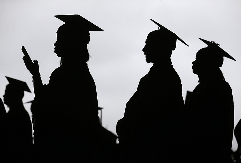 FILE - In this May 17, 2018, file photo, new graduates line up before the start of the Bergen Community College commencement at MetLife Stadium in East Rutherford, N.J.  A deadline is fast approaching for teachers, librarians, nurses and others who work in public service to apply to have their student loan debt forgiven. New figures from the U.S. Department of Education show 145,000 borrowers have had the remainder of their debt canceled through the Public Service Loan Forgiveness program. (AP Photo/Seth Wenig, File)