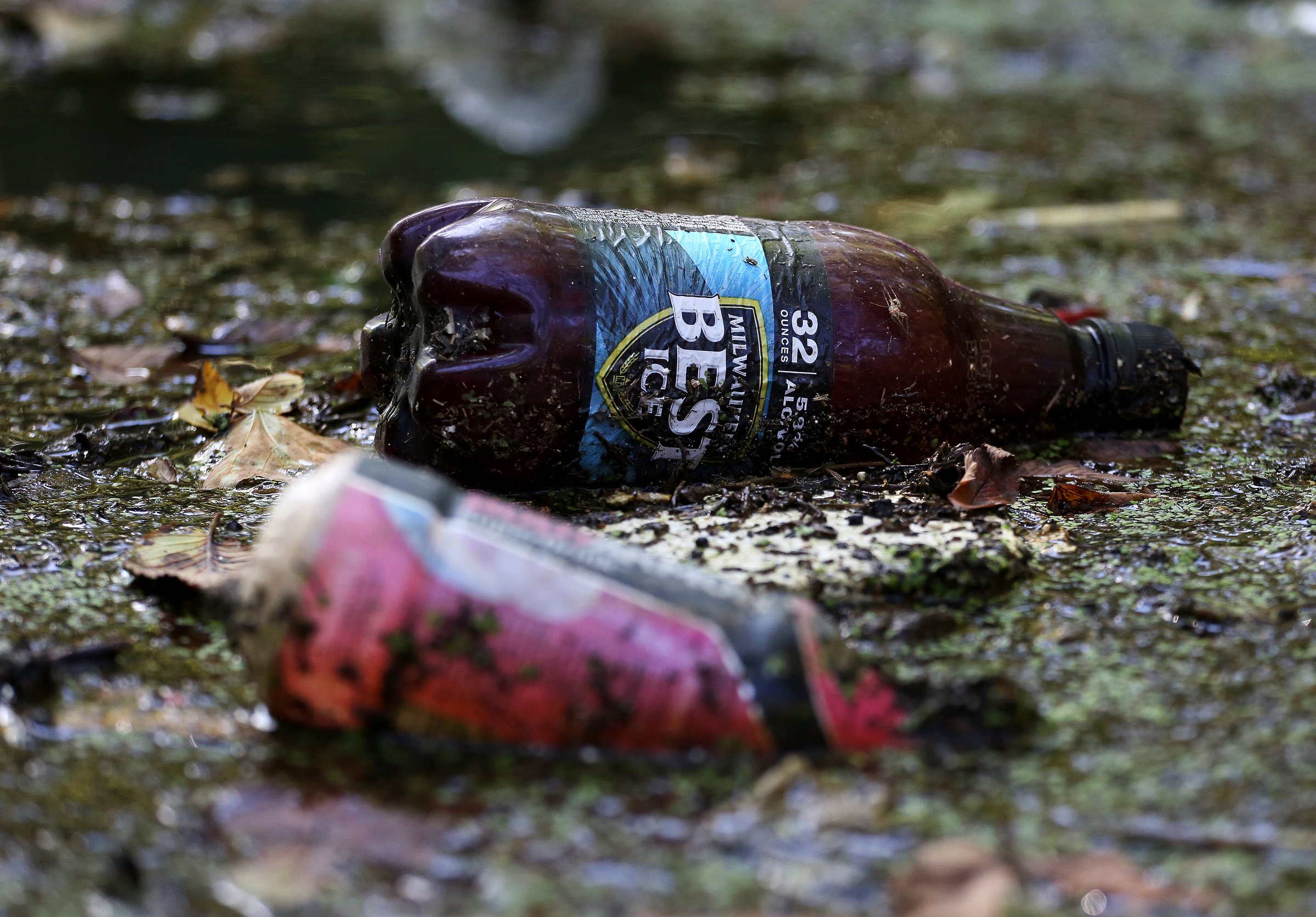 Staff Photo / Single-use containers float in water and debris along Chattanooga Creek in 2018 in Chattanooga.