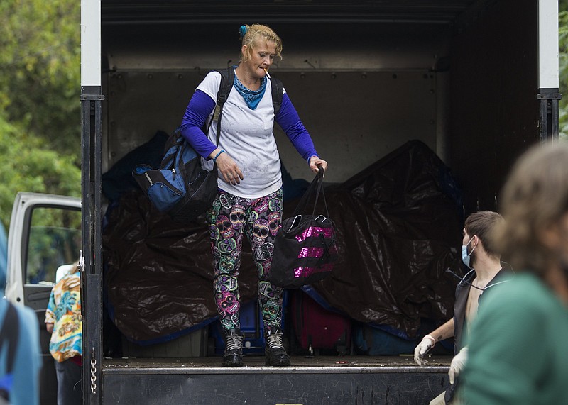 Staff photo / Crystal Ellis puts some of her belongings onto a moving truck after Chattanooga Police forced her and the other residents of a homeless encampment located off Workman Road off the property on Sept. 29, 2020, in Chattanooga.