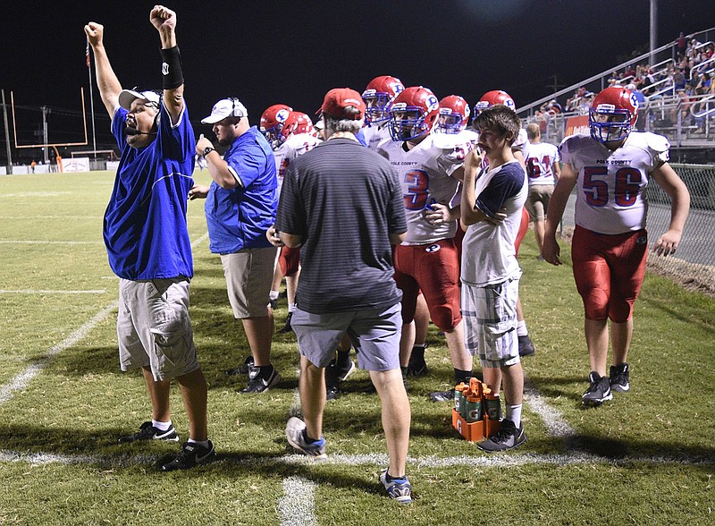 Staff photo by Robin Rudd / Polk County football coach Derrick Davis, left, signals to his team during a game in 2018. That was the final season of his first stint with the Wildcats, but Davis returned this summer and led his alma mater to a victory against Copper Basin in last week’s opener.