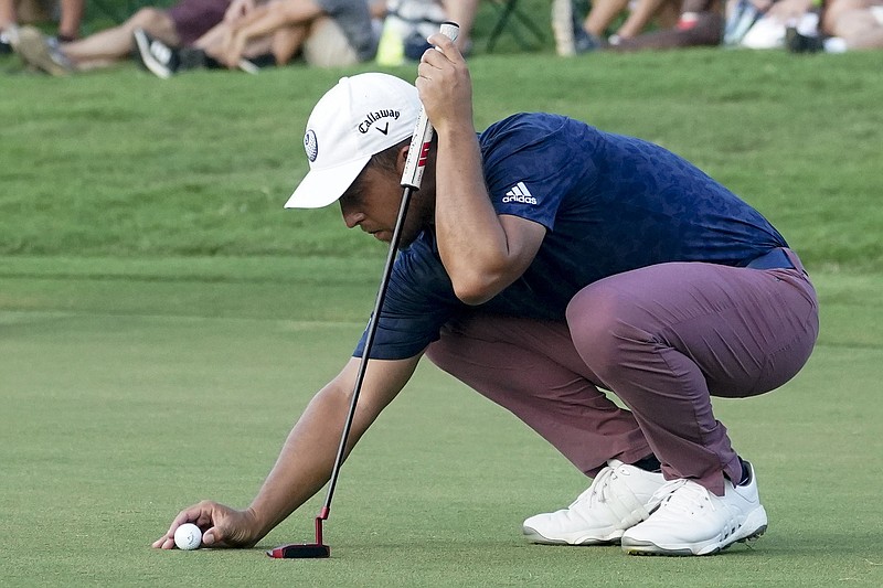 AP photo by John Bazemore / Xander Schauffele lines up a putt on the 18th green at East Lake Golf Club during the second round of the Tour Championship on Friday in Atlanta.