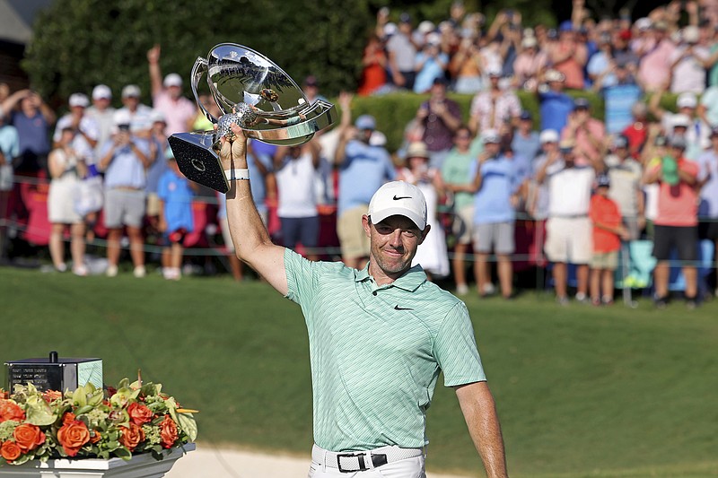 Atlanta Journal-Constitution photo by Jason Getz via AP / Rory McIlroy celebrates with his trophy after winning the Tour Championship and the $18 million FedEx Cup on Sunday at East Lake Golf Club in Atlanta. McIlroy, the most vocal player in defending the PGA Tour against upstart rival LIV Golf, called the tour “the best place in the world to play golf.”