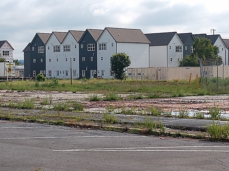 Staff Photo by Mike Pare / New housing is going up behind a site at Broad and West 33rd streets, shown Tuesday, Sept. 7, 2022, where new restaurant space is planned. A grocery store also is planned on the tract on Williams Street.