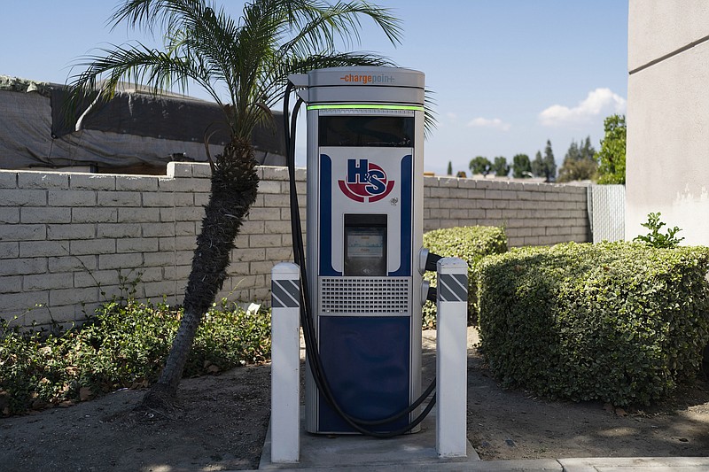 Photo by Jae C. Hong of The Associated Press / An electric vehicle charger stands in the parking lot of a gas station in South El Monte, Calif., on Friday, Aug. 26, 2022. Discounted prices, car-share programs, and a robust network of public charging stations are among the ways California will try to make electric vehicles affordable and convenient for people of all income levels as it phases out the sale of new gas cars by 2035.