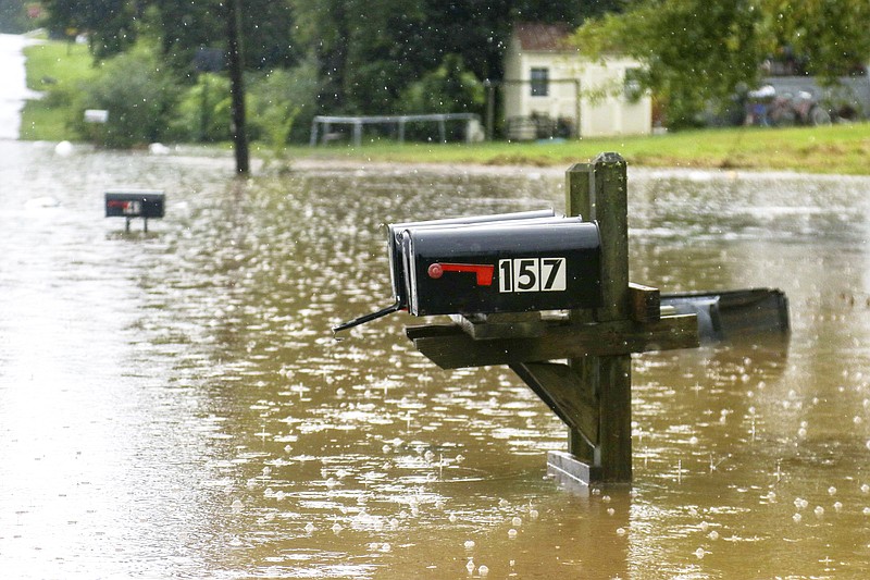 Bittings Avenue is seen partially underwater as many homes along the road were affected Sunday, Sept. 4, 2022, in Summerville, Ga