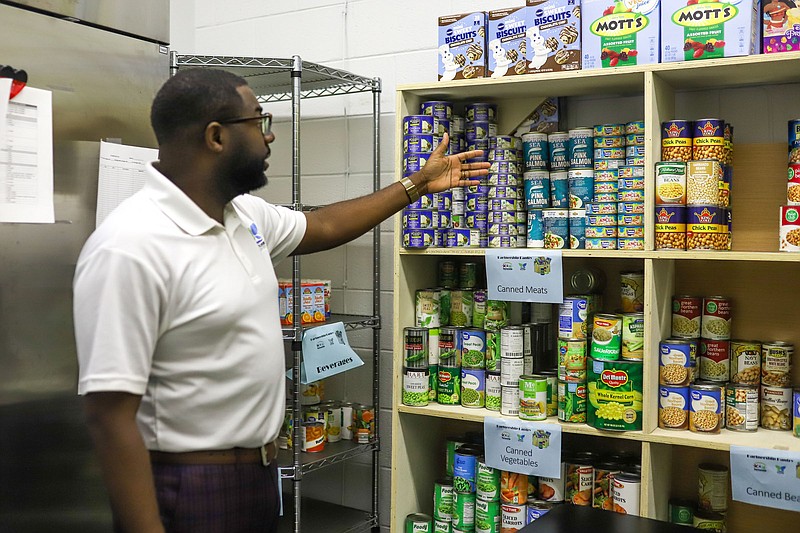 Staff photo by Olivia Ross  / Reggie Smith shows inside The Partnership Food Pantry at Bethlehem Center on September 12, 2022. Bethlehem Center has several community outreach initiatives that look to give back to the Alton Park area and surrounding.