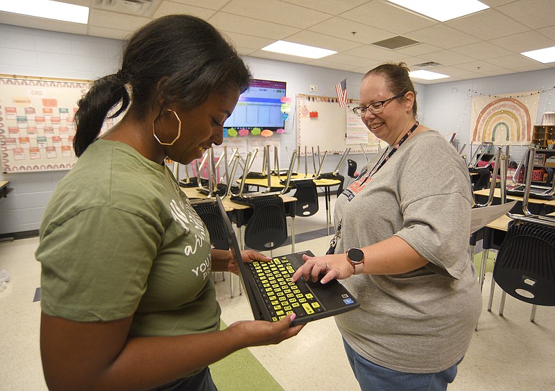 Staff photo by Matt Hamilton / Fourth grade reading teacher Tamela Cooley, left, and special education teacher Heather Modrow talk about the keyboard stickers with braille at East Ridge Elementary School on Friday, September 9, 2022.