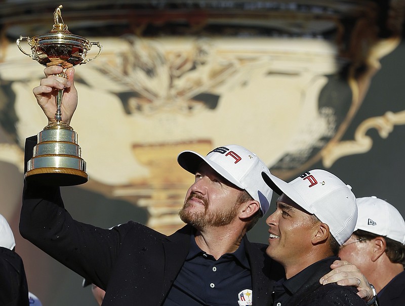 FILE - United States' Rickie Fowler and Jimmy Walker, left, celebrate during the closing ceremony of the Ryder Cup golf tournament on Oct. 2, 2016, at Hazeltine National Golf Club in Chaska, Minn. Walker wasn't expecting to play on the PGA Tour this 2022 season until nine players signed with LIV Golf, creating an exemption for Walker through a career money list.(AP Photo/David J. Phillip, File)