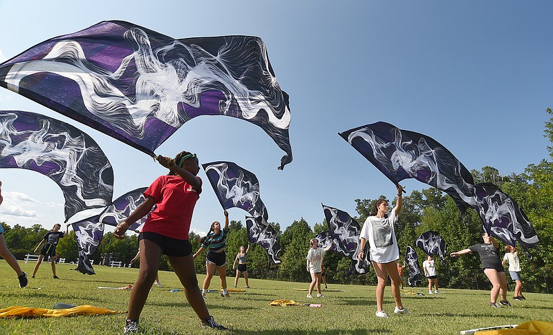 Staff photo by Matt Hamilton /  Color guard member Javian Radden, 15, front left, practices a routine during a band practice at Signal Mountain Middle/High School on Thursday, Sept. 15, 2022.