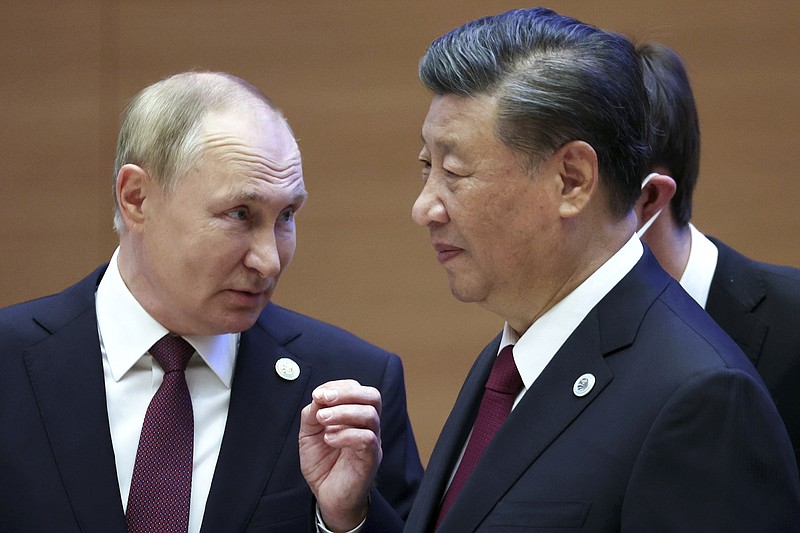 Photo by Sergei Bobylev, Sputnik, Kremlin Pool Photo via The AP / Russian President Vladimir Putin, left, gestures while speaking to Chinese President Xi Jinping during the Shanghai Cooperation Organization summit in Samarkand, Uzbekistan, on Friday, Sept. 16, 2022.