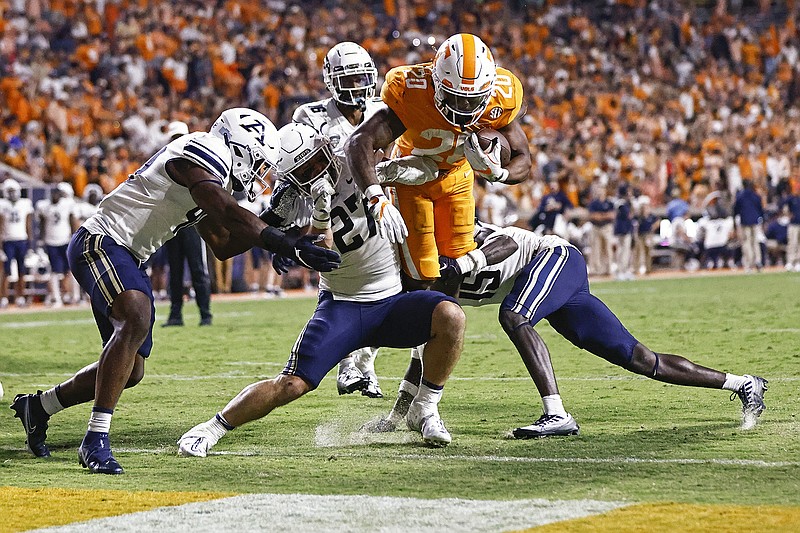 AP photo by Wade Payne / Tennessee running back Jaylen Wright (20) leaps for the end zone as he’s tackled by Akron linebacker Bubba Arslanian (27), defensive back KJ Martin (15) and linebacker Bryan McCoy (40) during the second half of Saturday night's game in Knoxville.