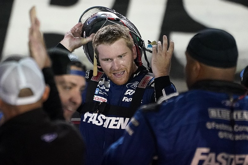 AP photo by Mark Humphrey / RFK Racing driver Chris Buescher takes off his helmet after winning Saturday night's NASCAR Cup Series race at Tennessee's Bristol Motor Speedway.